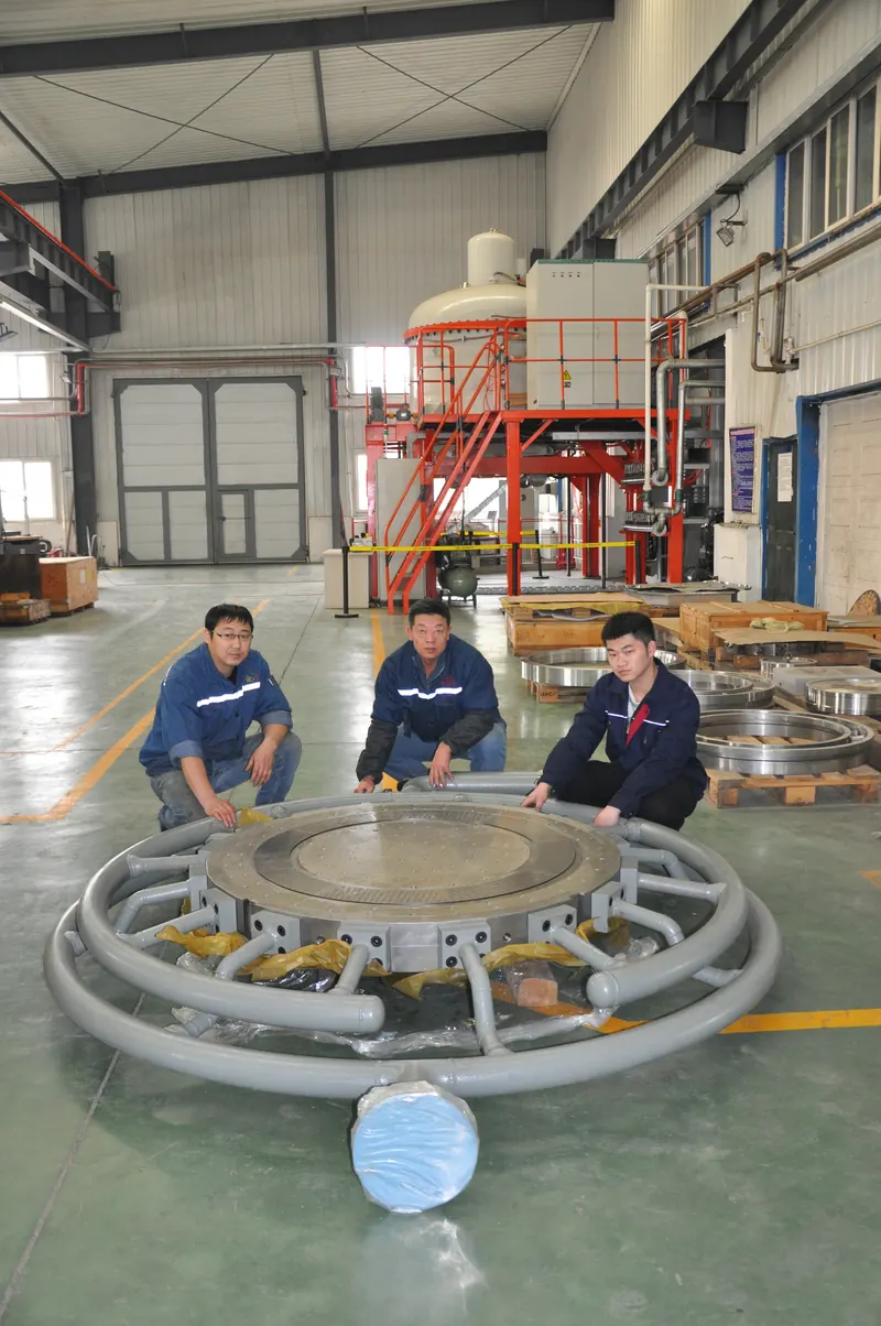 JINFENG team with a large die plate on the workshop floor